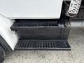 Close-up of the steps of a 1998 Freightliner FL80 featuring two black metal steps with textured surfaces for traction and a sturdy silver frame