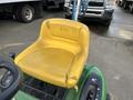 A yellow seat with visible wear and tear from a 2021 John Deere L Series S lawn tractor