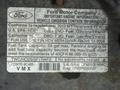 2012 Ford Econoline displaying an emissions control information label with vehicle specifications and fuel capacity details