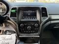 The interior of a 2020 Jeep Grand Cherokee featuring a central touchscreen display and various control buttons