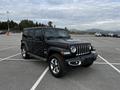 A black 2019 Jeep Wrangler parked in a lot showing its iconic seven-slot grille and rugged design