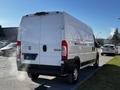 A white 2019 RAM Promaster van with a high roof and a rear view showing the tailgate and exhaust smoke coming out