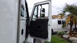 Side view of a 2012 International 7400 truck with the driver's door open, revealing the interior and side mirror