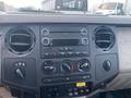 Dashboard of a 2009 Ford F-450 SD featuring air conditioning controls radio display and various buttons and knobs for vehicle settings