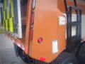 A 2016 International WorkStar 7500 truck with a brown and yellow patterned back panel showcasing red taillights and large black tires