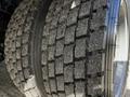 Close-up of a heavily worn tire from a 2008 Ford F-550 showcasing deep tread patterns and significant dirt accumulation