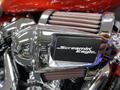 Close-up of a chrome air intake with the label Screamin' Eagle on a 2024 Harley Davidson Fat Boy motorcycle