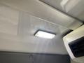 A ceiling light fixture inside a 2017 Chevrolet Express van illuminating the interior space