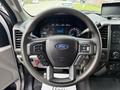 Steering wheel of a 2021 Ford F600 with Ford branding and controls for audio and cruise settings