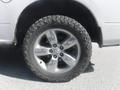 A close-up of a silver 2019 RAM 1500 Classic Eco Diesel wheel with a rugged tire featuring a distinctive tread pattern and alloy rims