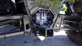 A close-up of the undercarriage of a 2016 Polaris Ranger 570 Crew showcasing the suspension system and drivetrain components