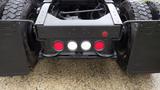 Close-up of the rear of a 2019 Western Star Trucks 4900 featuring tail lights and mud flaps