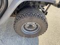 Close-up of a rugged tire mounted on a metallic rim from a 2018 Kubota RTV-X 1100 C showcasing its tread pattern and wheel structure