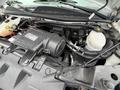 Engine compartment of a 2017 Chevrolet Express featuring components like the air intake system and various fluid reservoirs