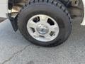 A close-up of the tire and wheel of a 2012 Ford F-150 displaying a chrome wheel hub and tire tread pattern