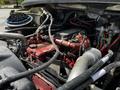 The image shows the engine compartment of a 2010 Freightliner M2 106 highlighting various components including hoses wires and a red engine block
