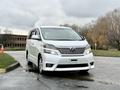 A white 2009 Toyota Vellfire is parked with its front facing the viewer showcasing its sleek design and modern features