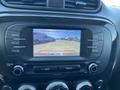 A 2017 Kia Soul dashboard displaying a rearview camera screen with guidelines for parking assistance