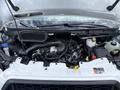 Engine compartment of a 2023 Ford Transit featuring a large air intake manifold battery coolant reservoir and various engine components