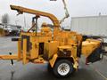 A yellow 1993 Bandit 200+ wood chipper with a feeding chute and trailer hitch visible