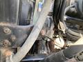 A close-up of the engine components of a 2014 International 7400 showing various hoses and metal parts with some signs of rust