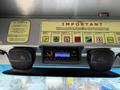 2012 Ford Econoline dashboard featuring a stereo system and two speakers with a display panel containing important policy information