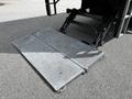 A metal ramp is extended from the back of a 2020 Hino 338 truck for loading and unloading cargo