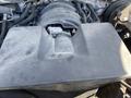 Close-up of the engine cover of a 2014 GMC Sierra 1500 showing a smooth surface with some dust and wear
