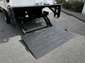 A hydraulic liftgate attached to the rear of a 2018 Hino 195 truck in a lowered position ready for loading or unloading cargo