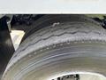 Close-up of a 2016 Ford F-750 tire showing tread pattern and wear with visible details on the rubber surface