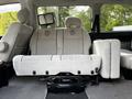 Interior view of a 2003 Mitsubishi 7 Passenger Van showing the passenger seats with light grey upholstery and adjustable headrests