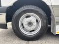 Close-up of a wheel and tire from a 2020 Chevrolet Express featuring aluminum rim and all-terrain tread pattern