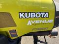 Close-up of a yellow Kubota F3990 tractor with a prominent logo and details on the side indicating the model and a machinery dealer