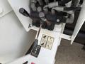A close-up view of the control panel on a 2011 International 4300 featuring several levers and a label indicating functions and settings