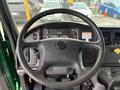 Steering wheel of a 2015 Freightliner M2 106 with dashboard controls and gauges visible