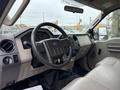 Interior of a 2008 Ford F-250 SD showing the steering wheel dashboard and center console with controls and seating in light beige upholstery