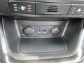 A close-up view of the interior of a 2015 Kia Sorento showing two 12V power outlets one USB port and an AUX input in a storage compartment