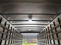 Interior view of a 2022 International MV607 truck showing metal walls and wooden vertical supports with a rounded ceiling and a light fixture in the center