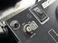 Close-up of the control panel of a 2012 Autocar Xpert showing ignition switch throttle control and a shutdown override button