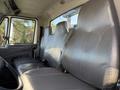 Interior view of a 2017 International 4300 truck showing three gray vinyl seats with a steering wheel visible in the foreground