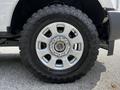 Close-up of the wheel and tire of a 2017 Ford F-250 SD featuring a silver alloy rim and an all-terrain mud tire with a rugged tread pattern