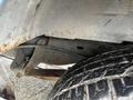 2009 Ford Econoline with visible tire tread and undercarriage components showing signs of wear and rust