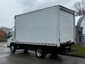 A white 2021 Mitsubishi FE box truck viewed from the rear with a large cargo area and a flatbed platform