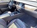 Interior view of a 2017 Genesis G80 showing black leather seats center console and dashboard with various controls and displays