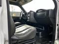 Interior view of a 2006 GMC C5000 featuring a black leather driver's seat and dashboard with controls and instrument panel visible