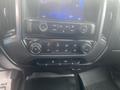 Dashboard controls of a 2015 Chevrolet Silverado 3500HD featuring audio and climate control buttons