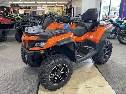 2022 Cfmoto CForce 80CC ATV 4x4 Quad in orange with a robust design and large black tires positioned on a showroom floor