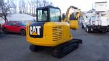 A yellow 2019 CAT 306E2 excavator featuring a cabin with glass windows and a prominent CAT logo on the side