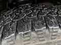 Close-up of a tire tread from a 2009 Ford Econoline showing deep grooves and patterns indicating all-terrain capabilities