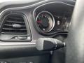 Close-up of the dashboard of a 2017 Dodge Challenger featuring the speedometer and control knobs